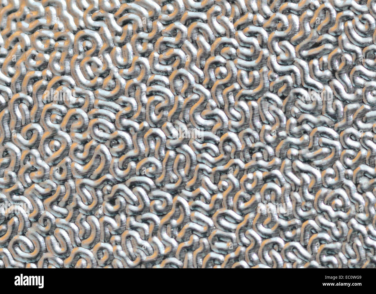 A macro closeup of silver foil with texture for background or copy space. Stock Photo