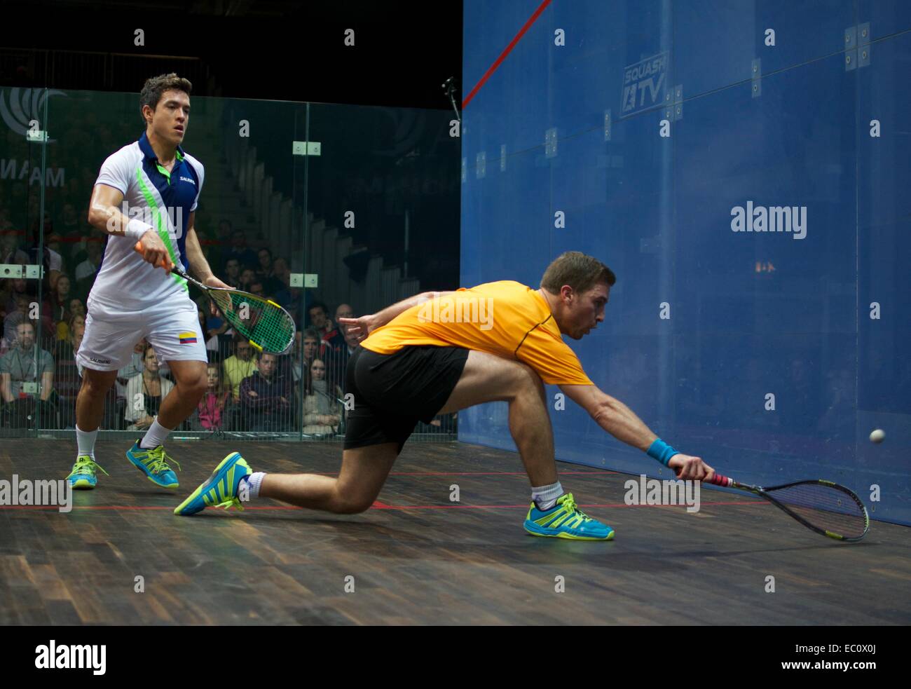 Manchester, UK. 7th Dec, 2014. Mathieu Castagnet (France) in yellow beats Miguel Angel Rodriguez (Colombia) 11-2, 16-14, 13-11 in the semi-final of the A J  Bell British  Squash Grand Prix. to go into tomorrow's final, where he will meet Nick Matthew (England), the three times World Champion. Squash British Grand Prix Credit:  John Fryer/Alamy Live News Stock Photo