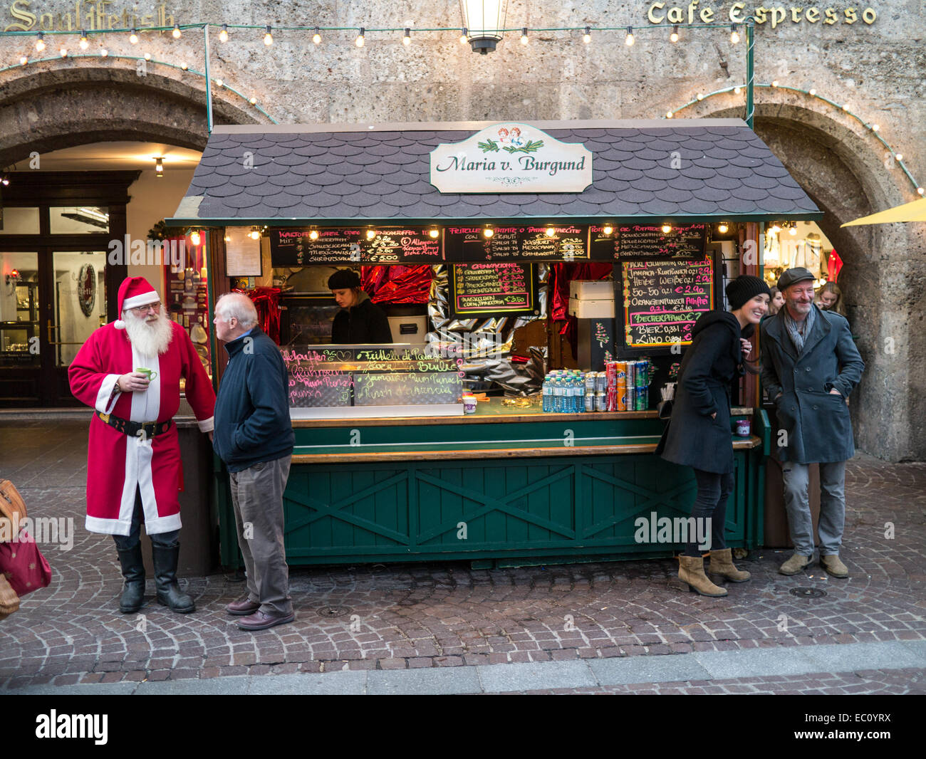 Santa enjoying a mulled wine with a friend at a Christmas market Stock Photo