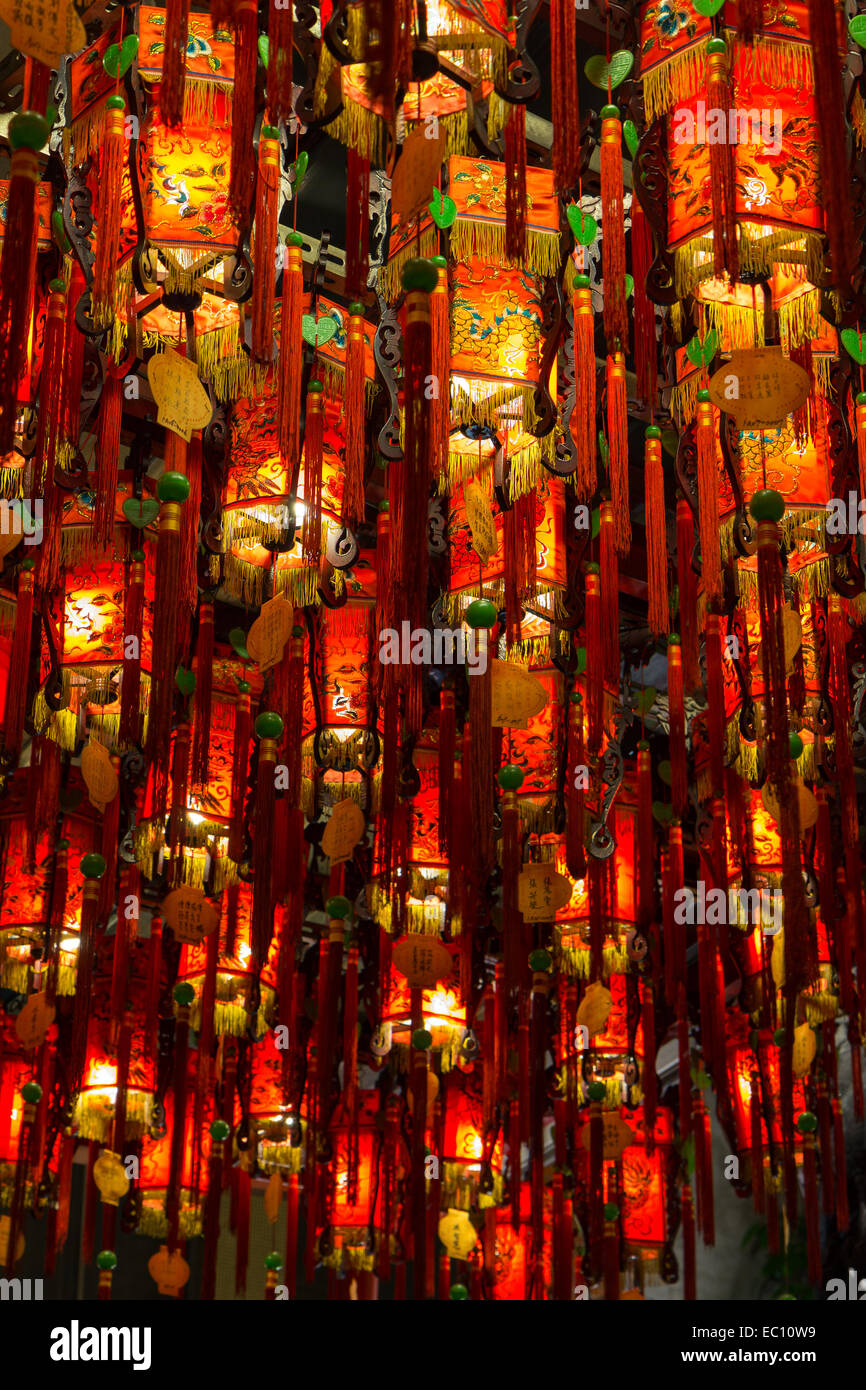 Closeup of many lit, colorful and oriental lamps/lanterns hanging from
