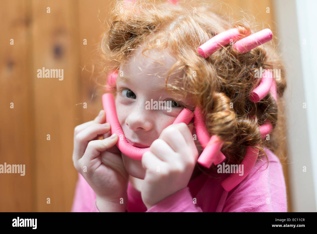 A little girl with bendy rollers in her hair Stock Photo Alamy