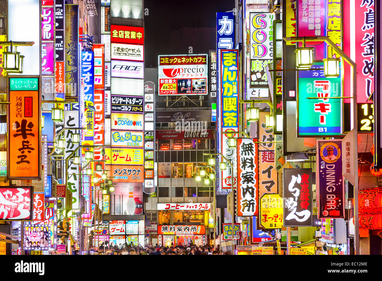 TOKYO, JAPAN - MARCH 14, 2014: Signs densely line an alleyway in Kabuki-cho. The area is a renown nightlife and red-light distri Stock Photo