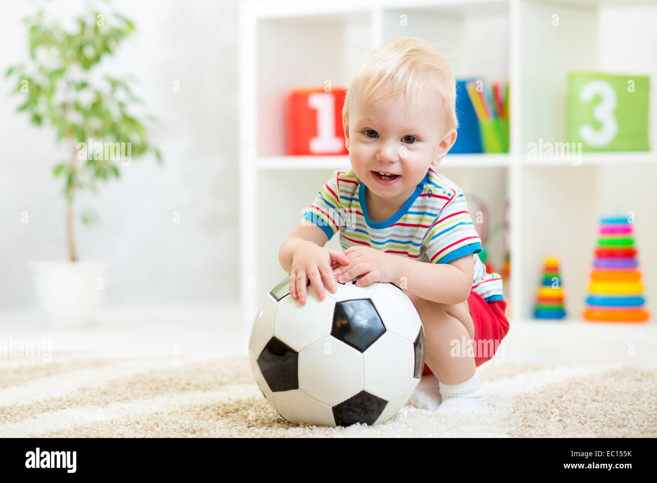 kid boy with football  indoor Stock Photo