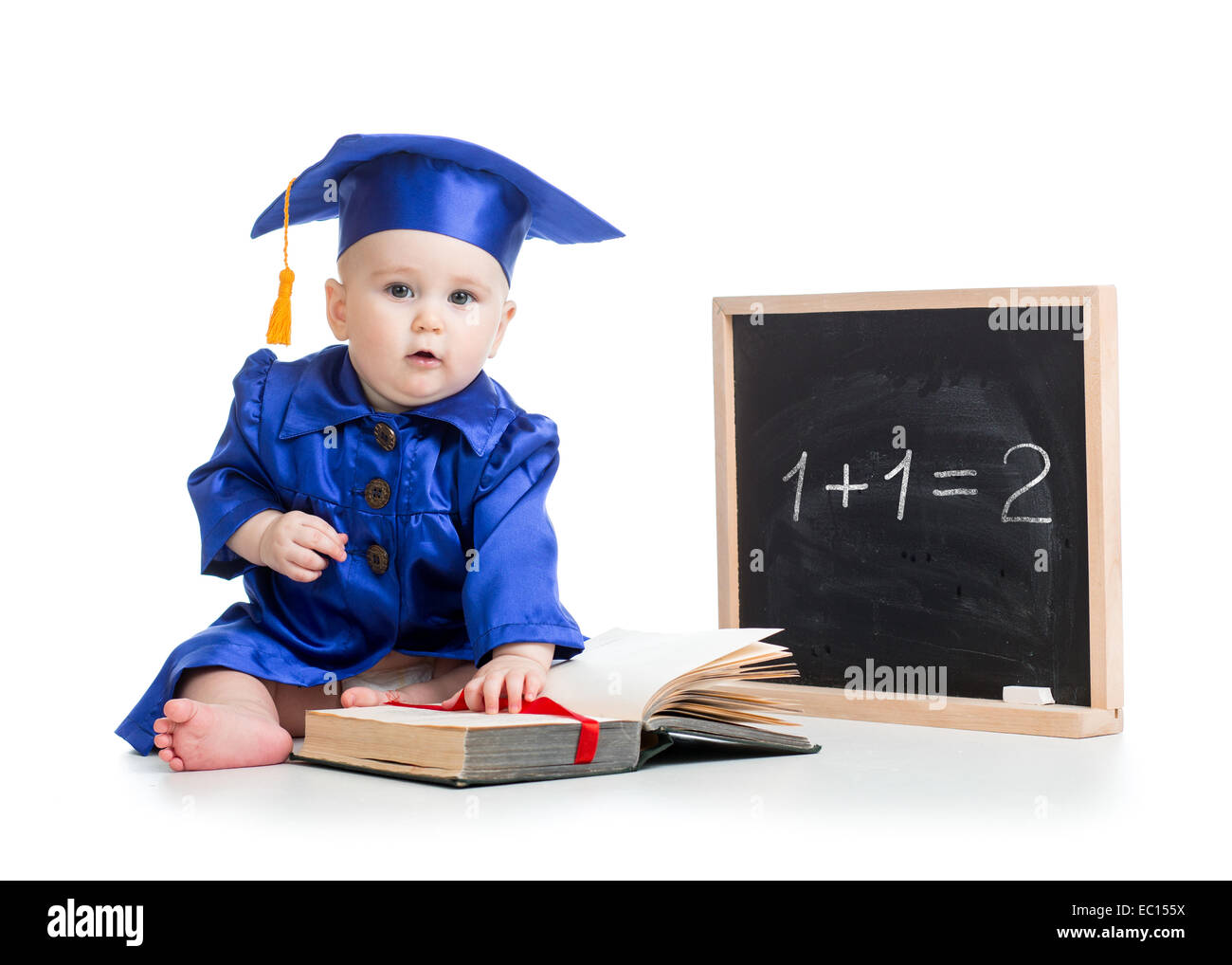 baby with open book in academician clothes at chalkboard Stock Photo