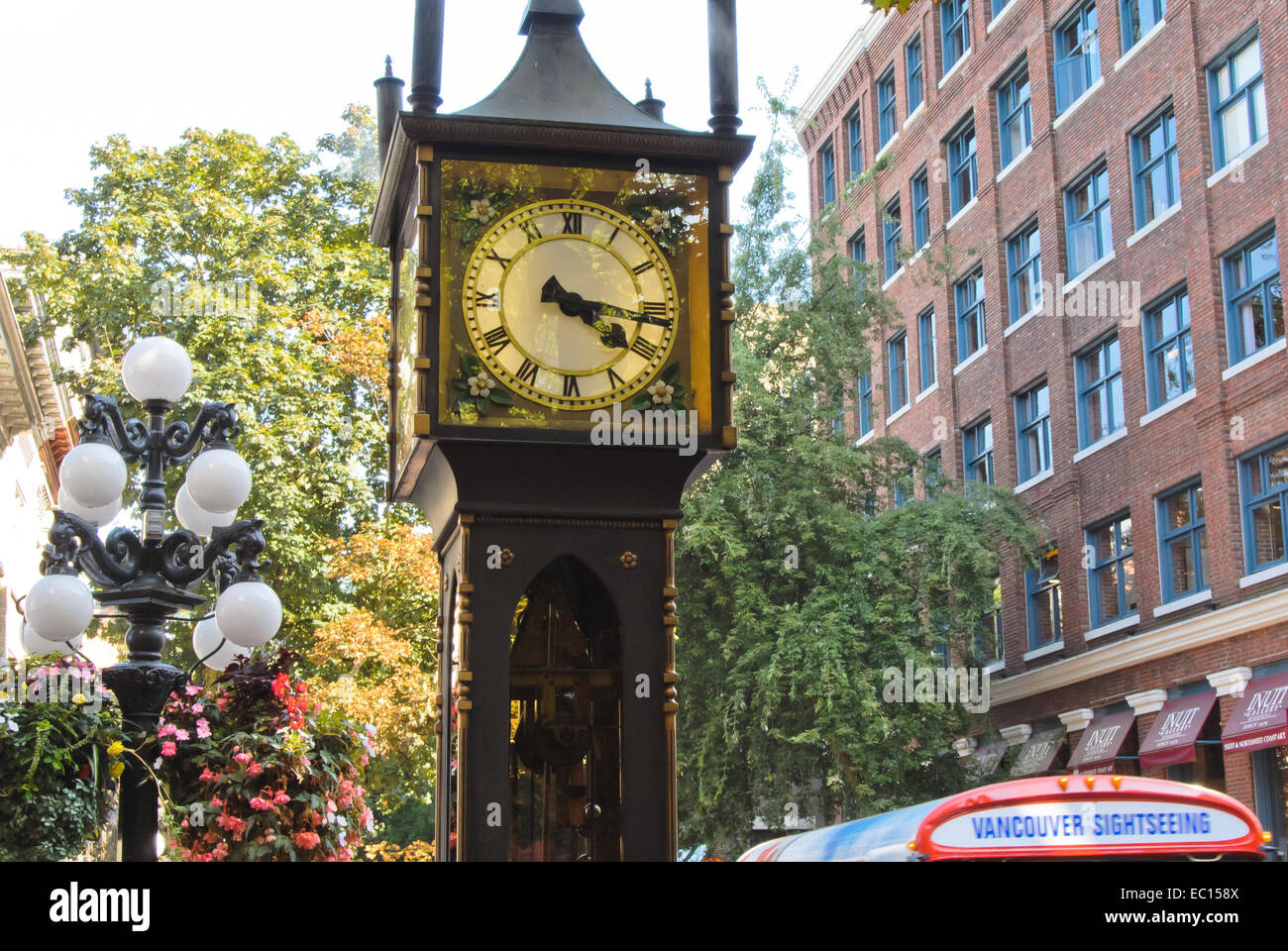 Vancouver steam clock in Gastown with tour bus in background Stock Photo