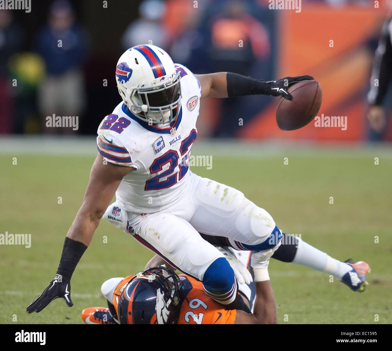 Denver, Colorado, USA. 7th Dec, 2014. Bills RB FRED JACKSON, center, runs for yardage as he tackled by Broncos CB BRADLEY ROBY, bottom, during the 2nd. Half at Sports Authority Field at Mile High Sunday afternoon. The Broncos beat the Bills 24-17. Credit:  Hector Acevedo/ZUMA Wire/Alamy Live News Stock Photo