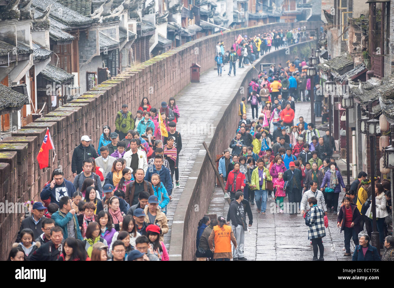 Crowds of tourists walk along the ancient city walls at Fenghuang, China Stock Photo