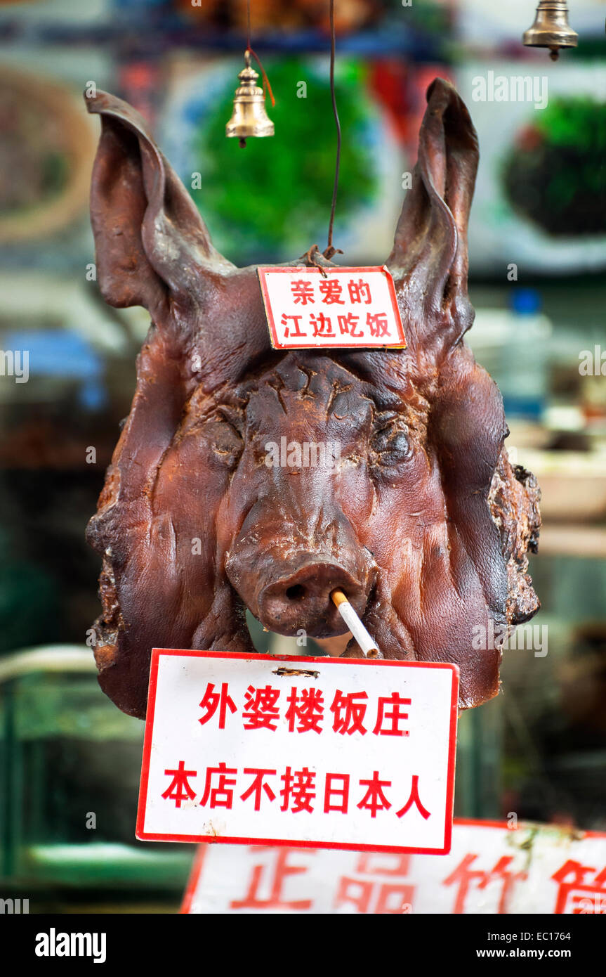 Pig's head with a 'no Japanese' sign attached Stock Photo