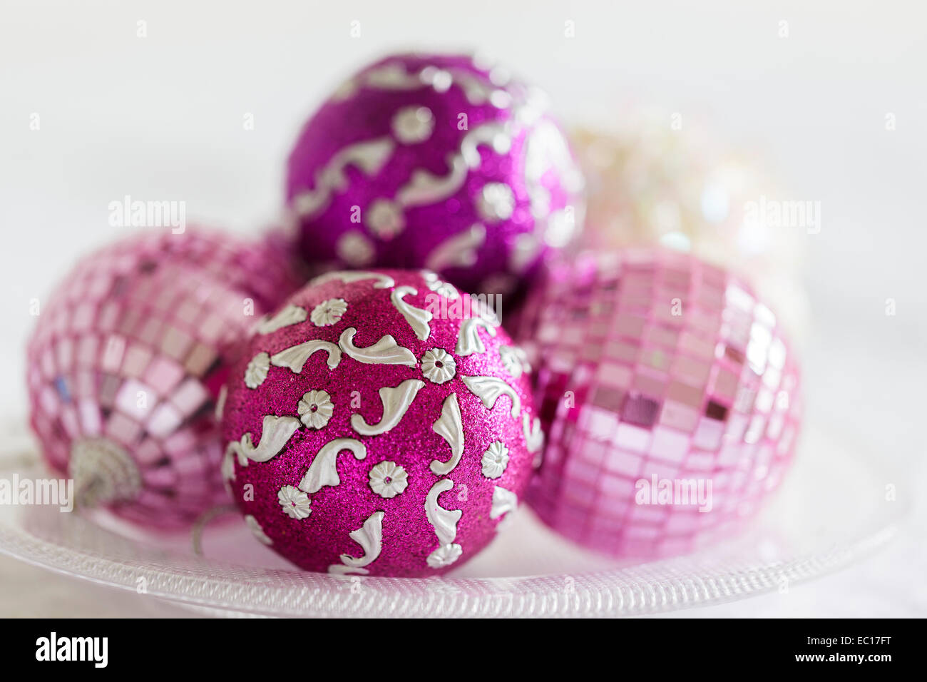 Pink and purple Christmas decorations on a glass plate Stock Photo
