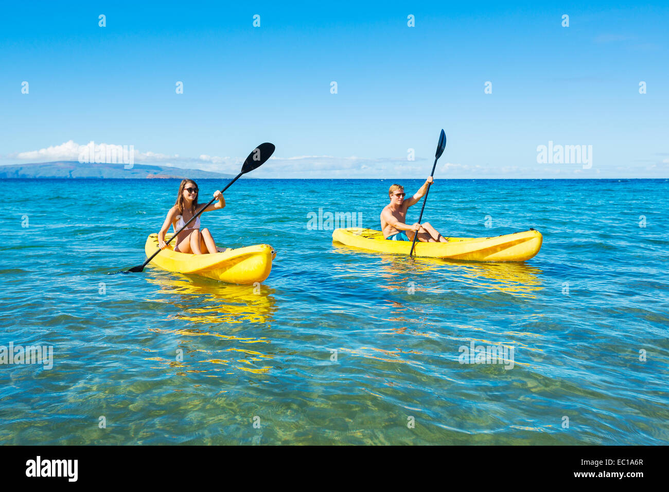 Couple Kayaking in the Ocean on Vacation Stock Photo