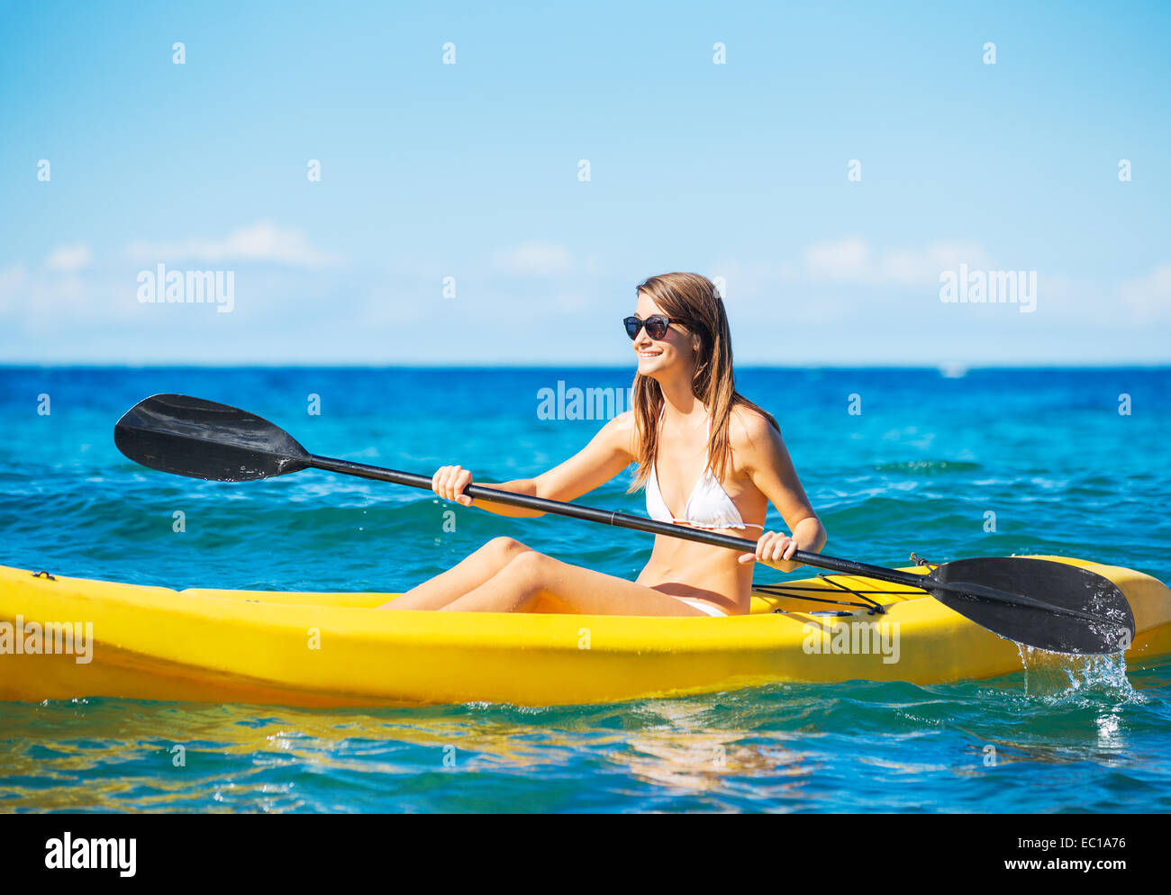 Woman Kayaking in the Ocean Stock Photo