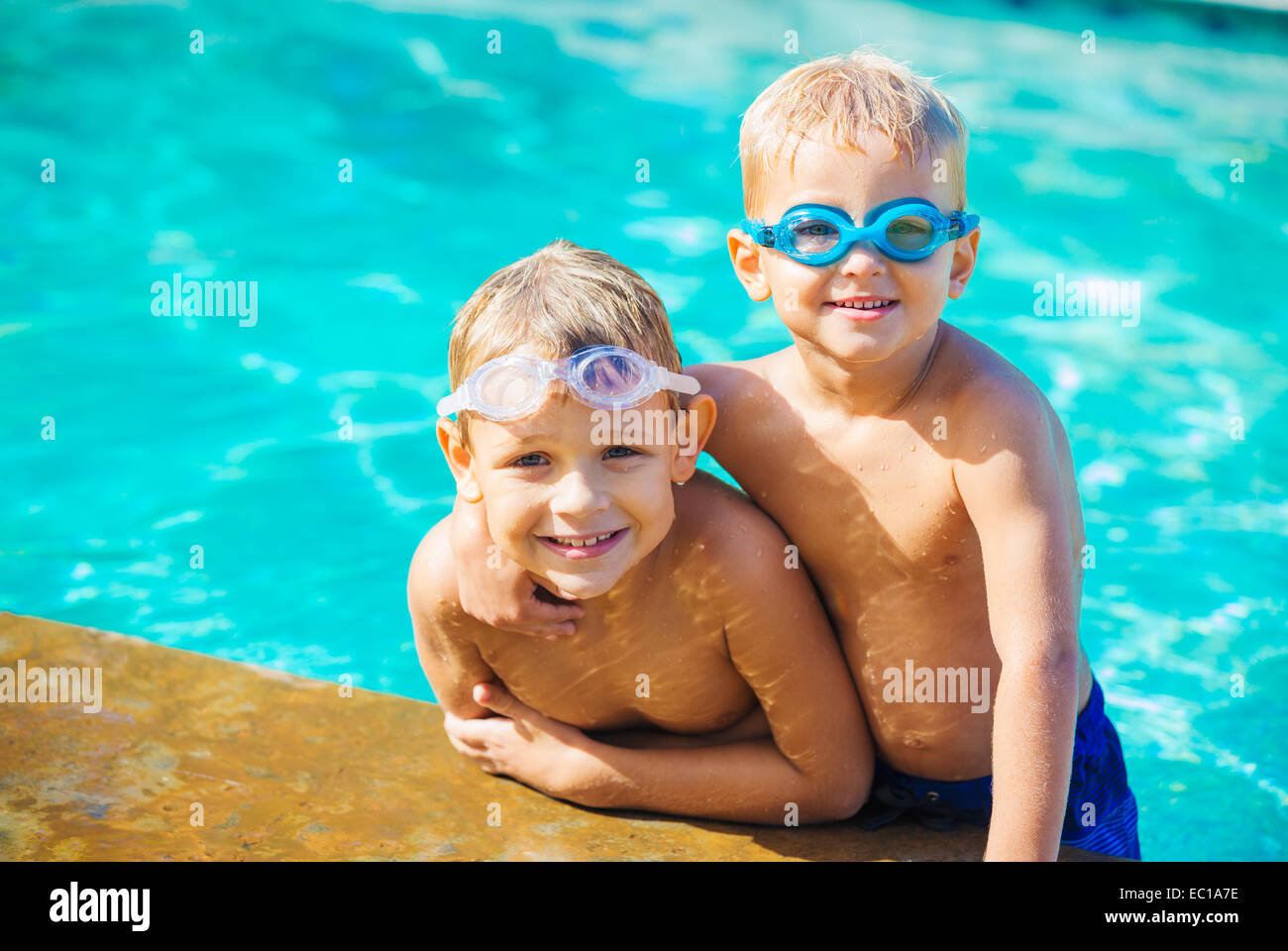Two Adorable Young Boys Having fun at the Pool. Summer Vacation Fun. Stock Photo