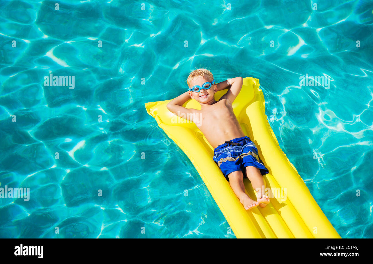Happy Young Boy Floating in Swimming Pool on Raft Stock Photo Alamy