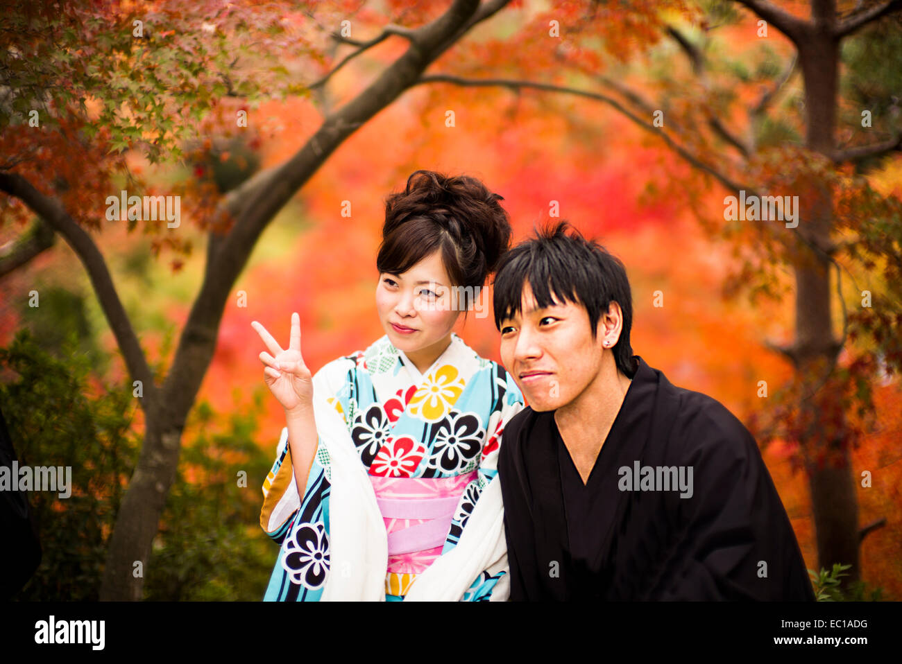 Young Japanese couple in traditional costume, enjoying the autumn color in Kyoto, Japan. Stock Photo