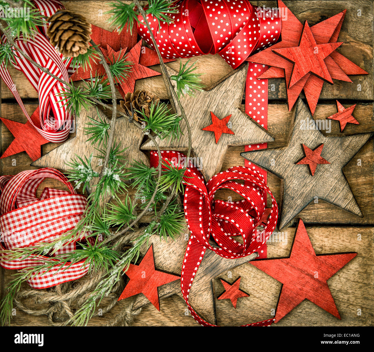 christmas decorations wooden stars and red ribbons. nostalgic retro style picture. dark designed image Stock Photo