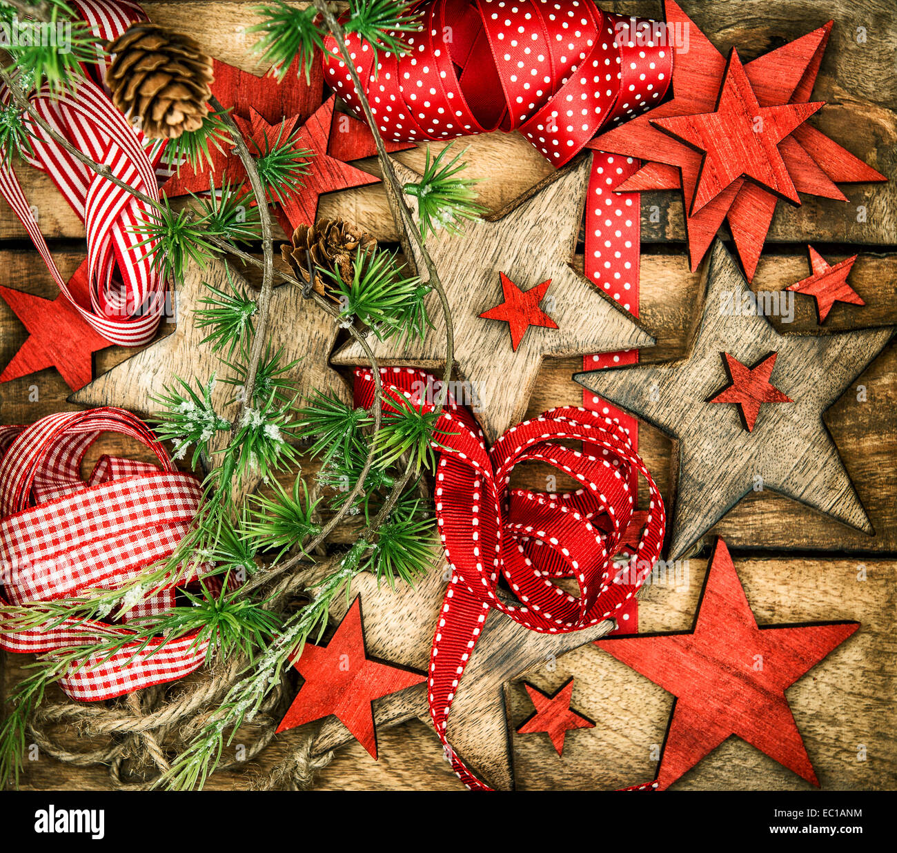christmas decorations wooden stars and red ribbons for gifts wrapping. nostalgic retro style toned picture Stock Photo