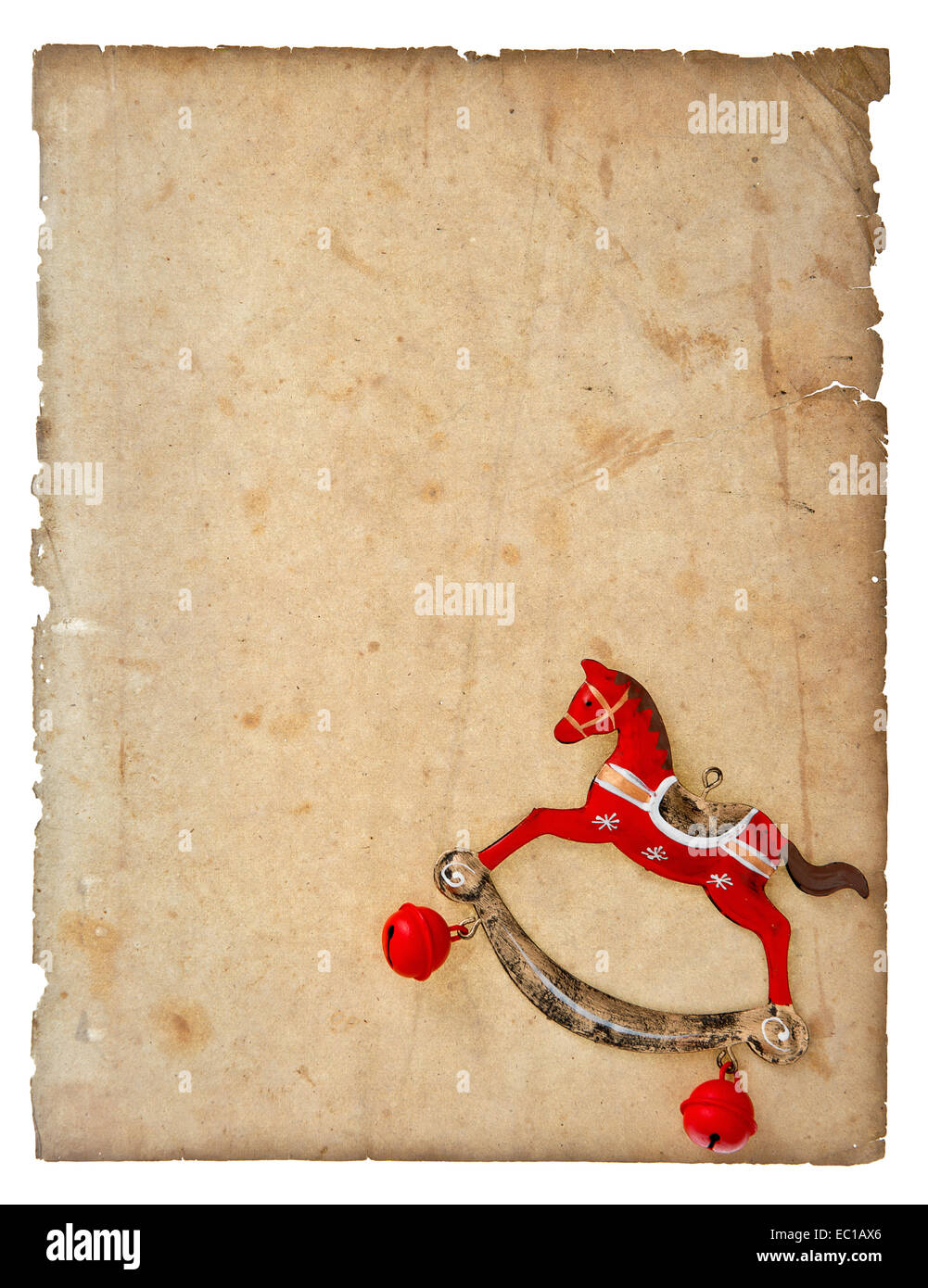 vintage christmas decoration rocking horse toy with aged paper page isolated on white background Stock Photo