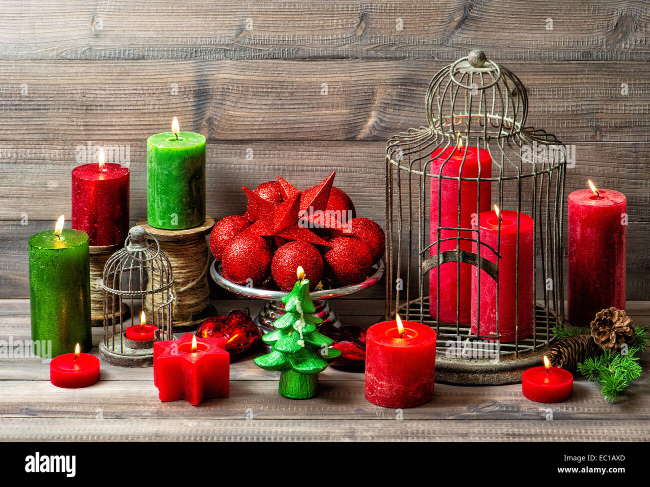 christmas still life with burning candles and red baubles. nostalgic home interior decoration Stock Photo