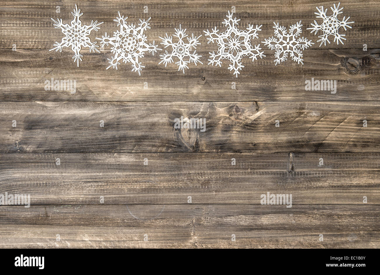 christmas ornament white snowflakes on rustic wooden background. festive decoration Stock Photo