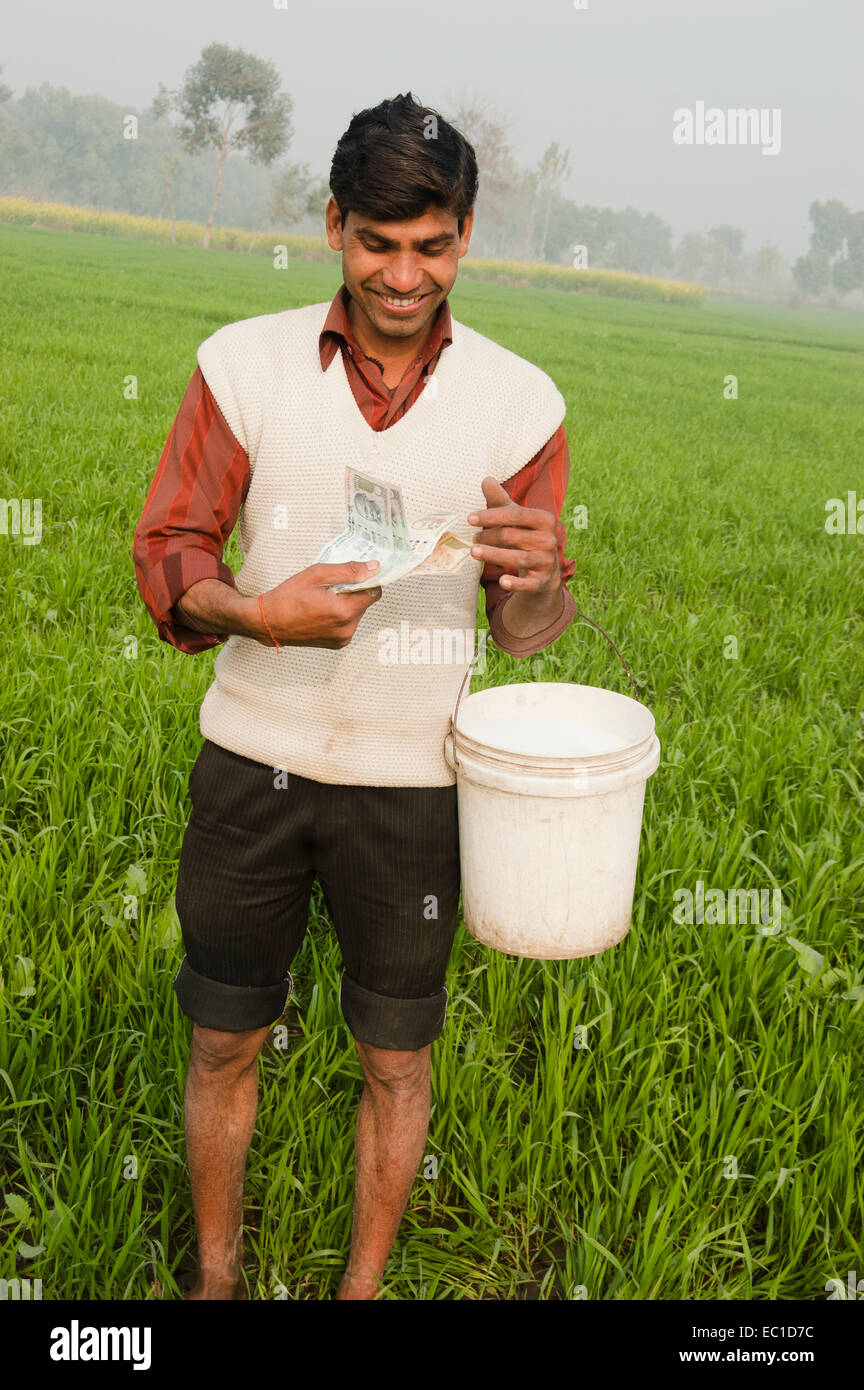 1 Indian Farmer Working in Farm and Counting Money Stock Photo