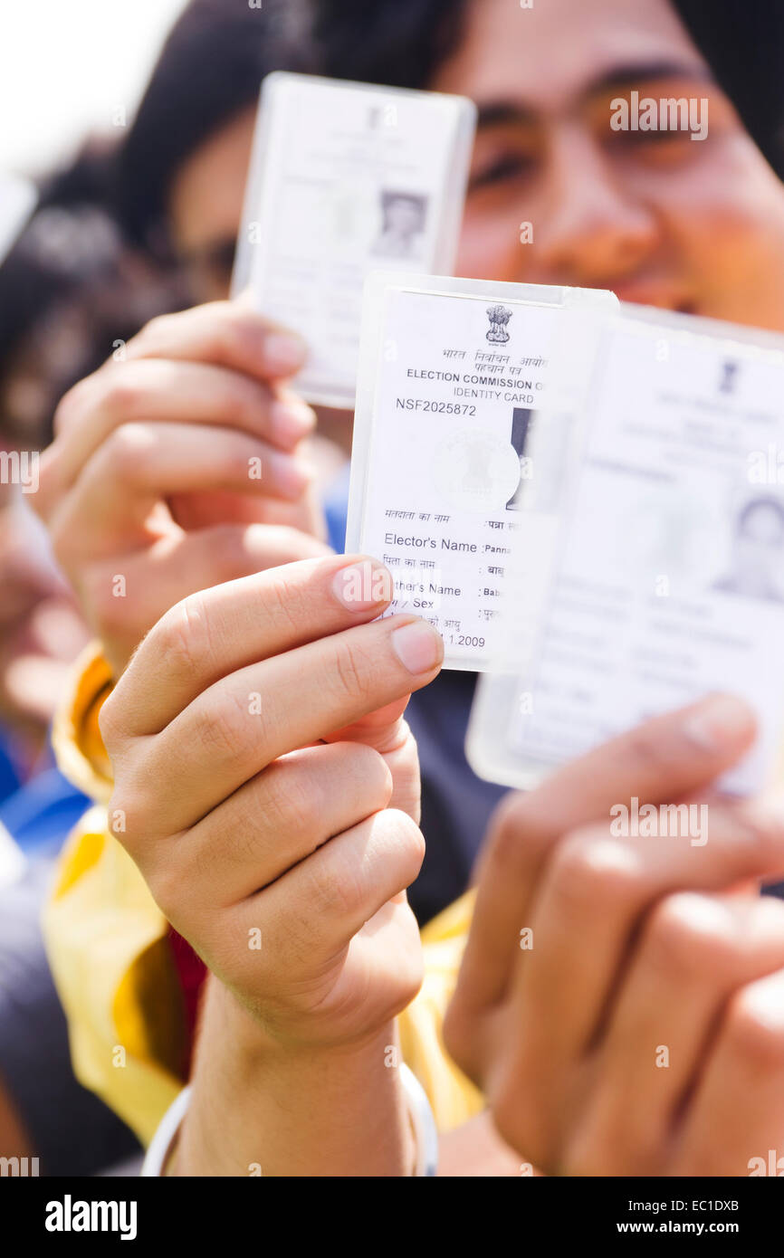 indian group crowds Election line with Voter id card Stock Photo
