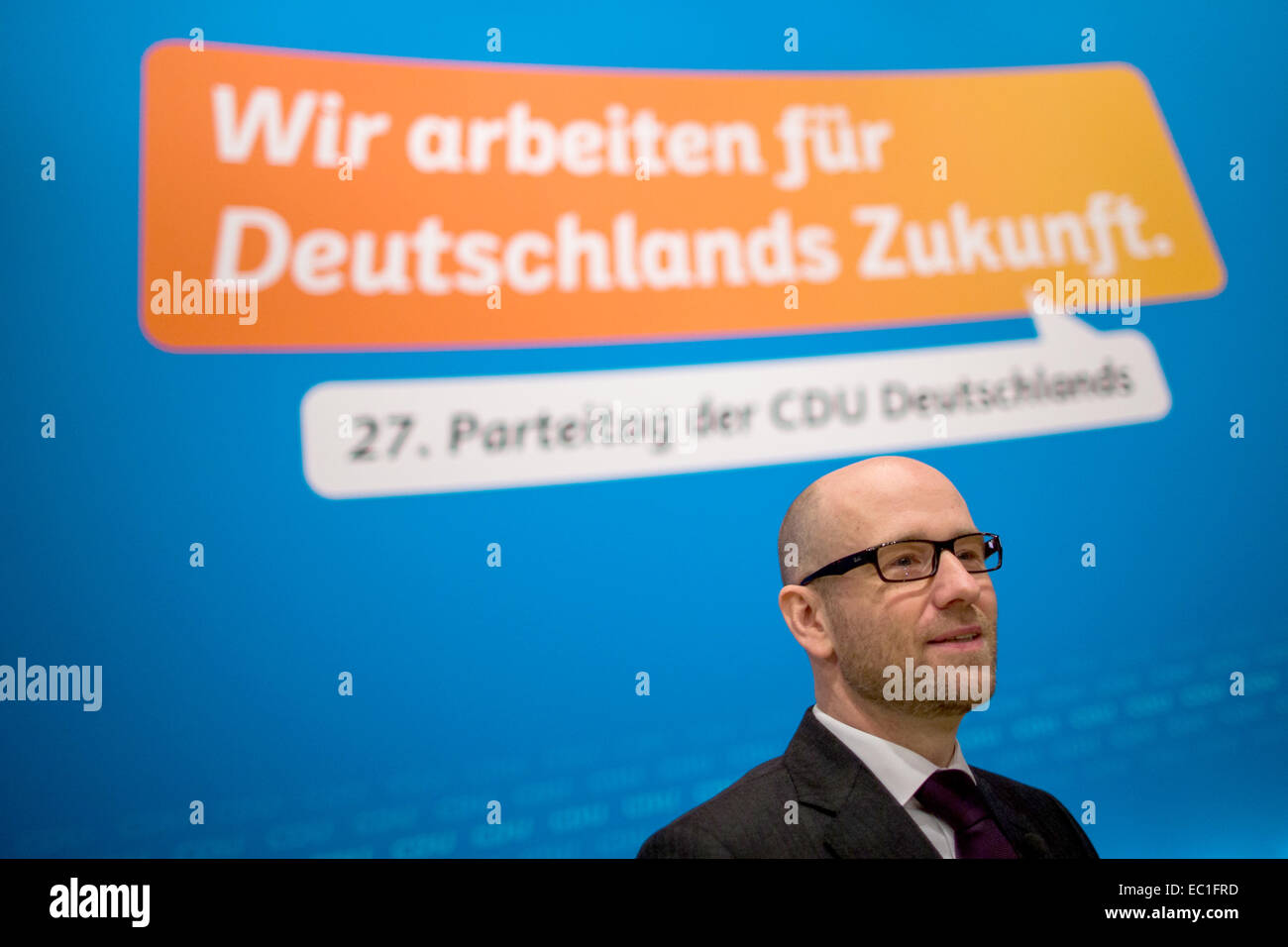 Cologne, Germany. 08th Dec, 2014. Secretary General of the Christian Democratic Union (CDU) Peter Tauber stands in front of the party motto 'We work for Germany's future' before the federal party convention in Cologne, Germany, 08 December 2014. The party convention takes place on Tuesday and Wednesday. Photo: ROLF VENNENBERND/dpa/Alamy Live News Stock Photo