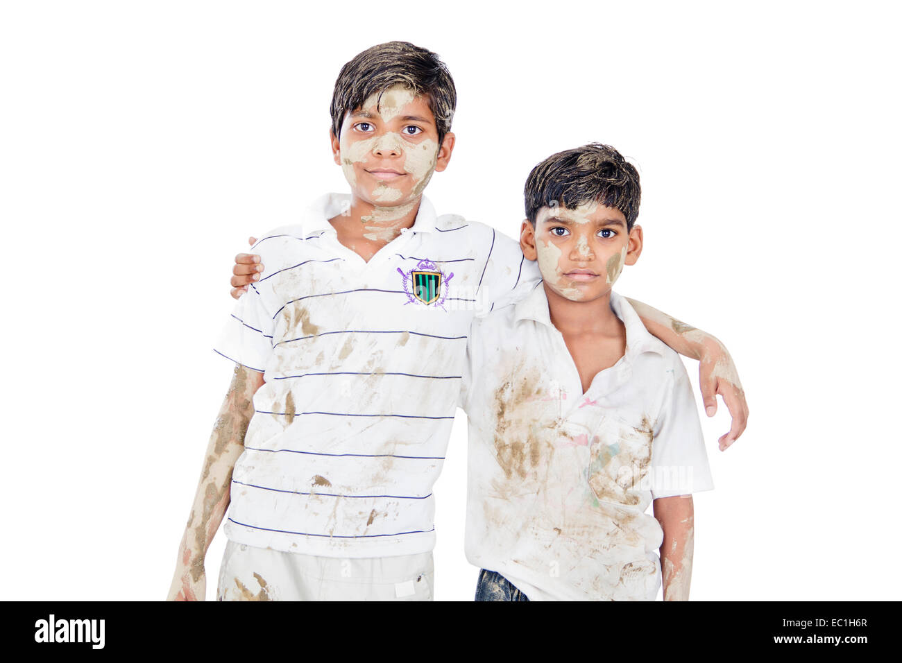 2 indans kids boys Friends Arm around standing Dirty Clothes Stock Photo