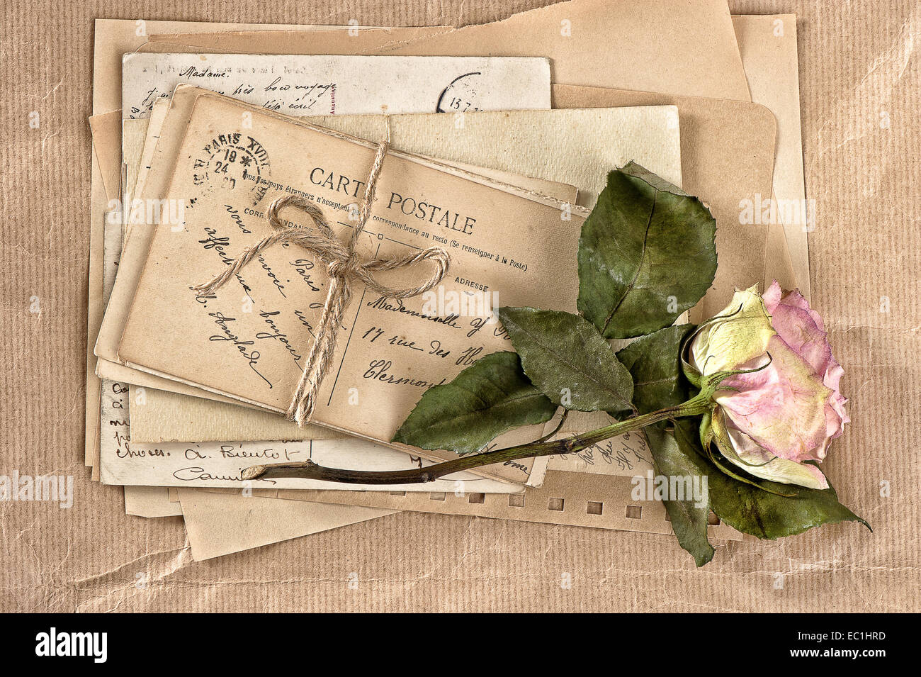 dried rose flower and old letters. vintage postcards and envelopes