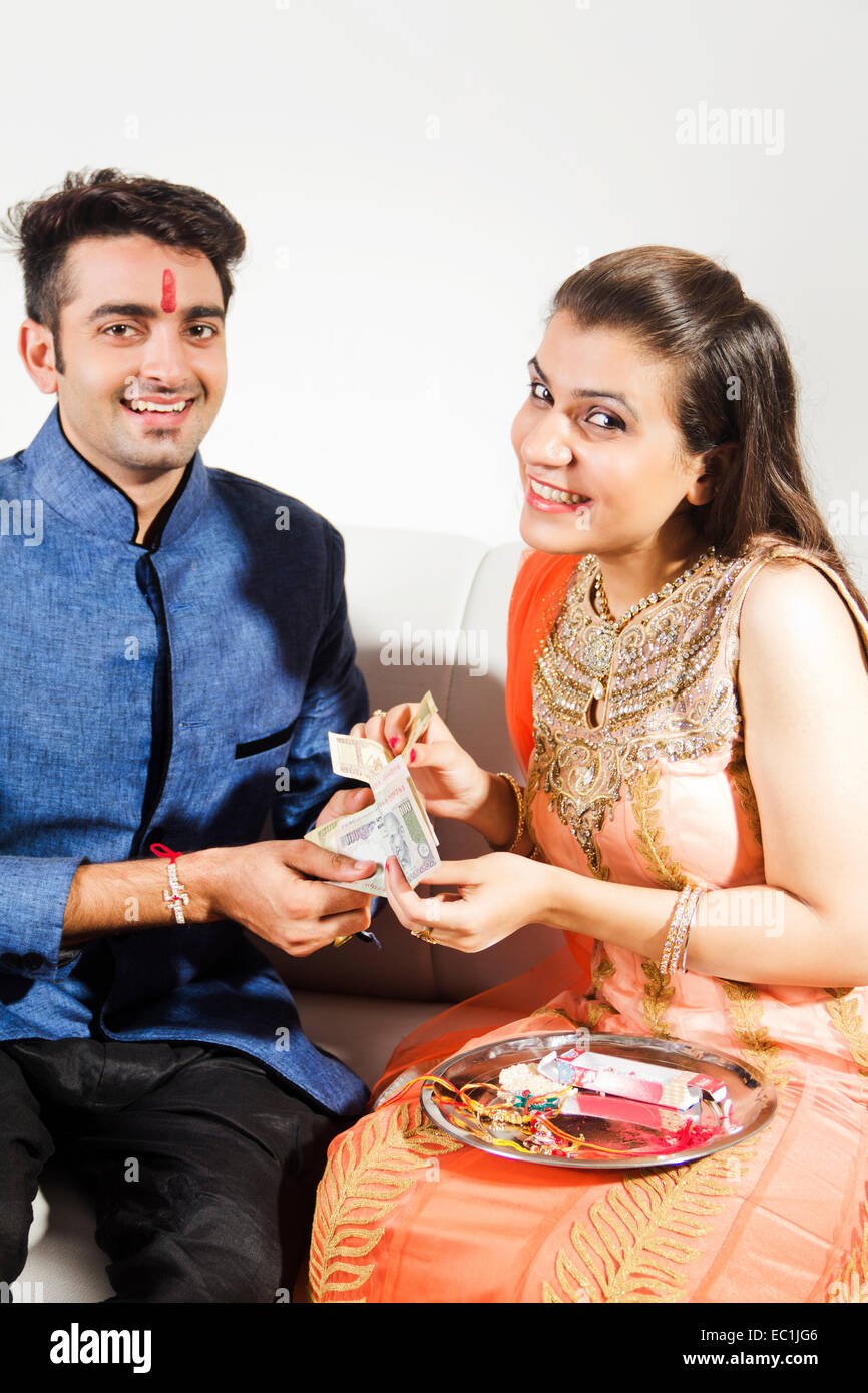 indian Brother and sister Raksha Bandhan giving money Stock Photo