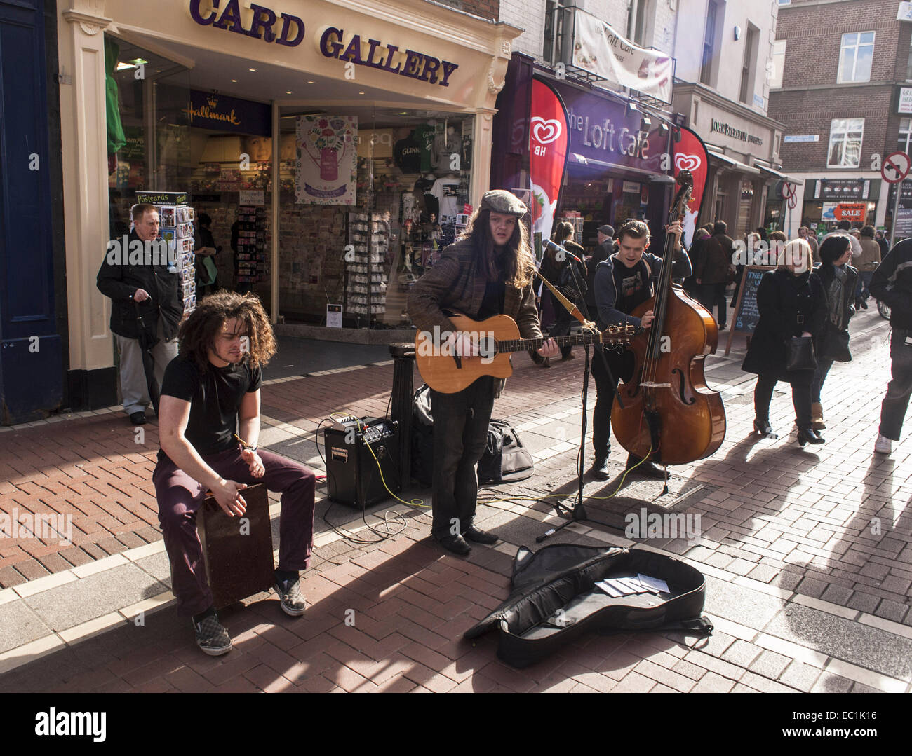 Irish buskers, Grafton St., Dublin. Playing guitar, double bass, percussion; amplified. On