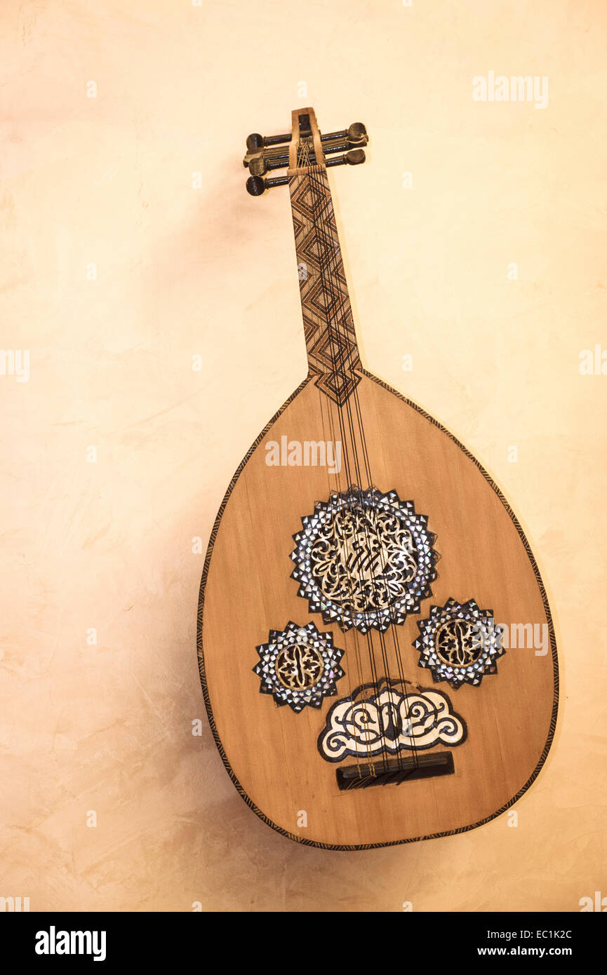 Oud, Arabic lute, displayed on wall. 3 + 3 strings (3 sympathetic). Common across the Middle East, the precursor of the western lute. The name oud (or ud) derives from the Arabic for 'wood', and this refers to the strips of wood used to make its rounded body. Stock Photo