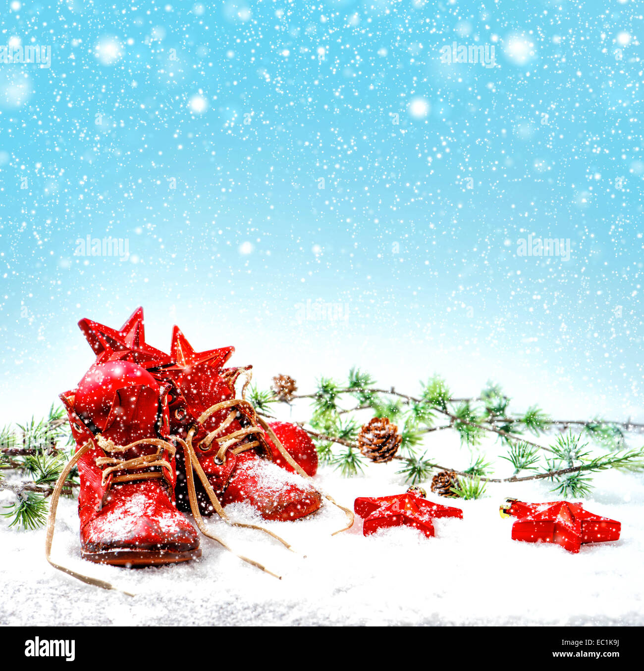 nostalgic christmas decoration with antique baby shoes. retro style toned picture with falling snow effect Stock Photo
