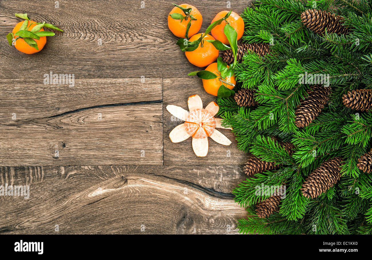 mandarine fruits and christmas tree branches on wooden background Stock Photo