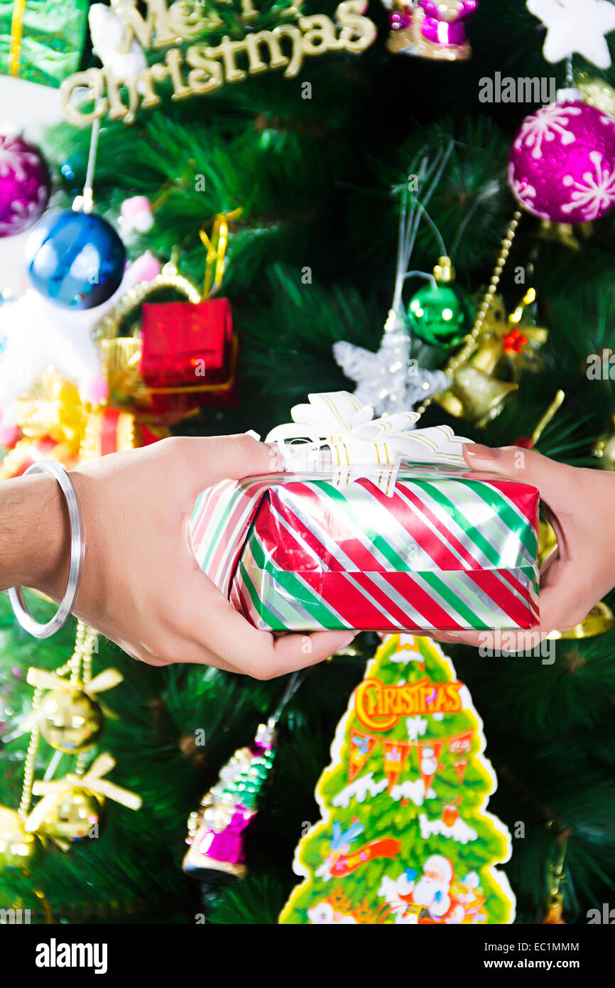 friend Christmas Tree Giving gift Stock Photo