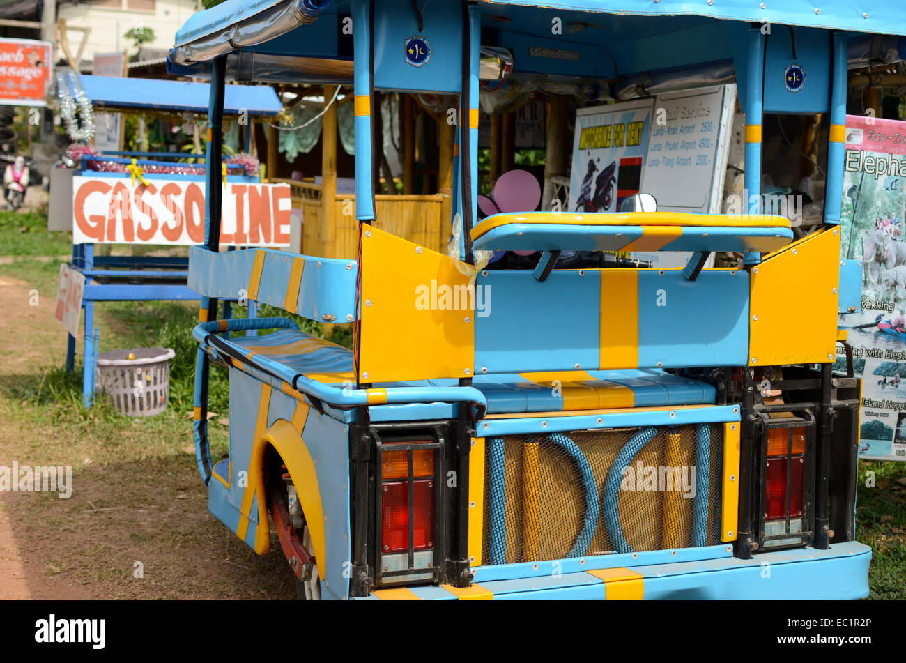 Brightly coloured song tao parked near gasoline stand, Ko Lanta, Thailand Stock Photo