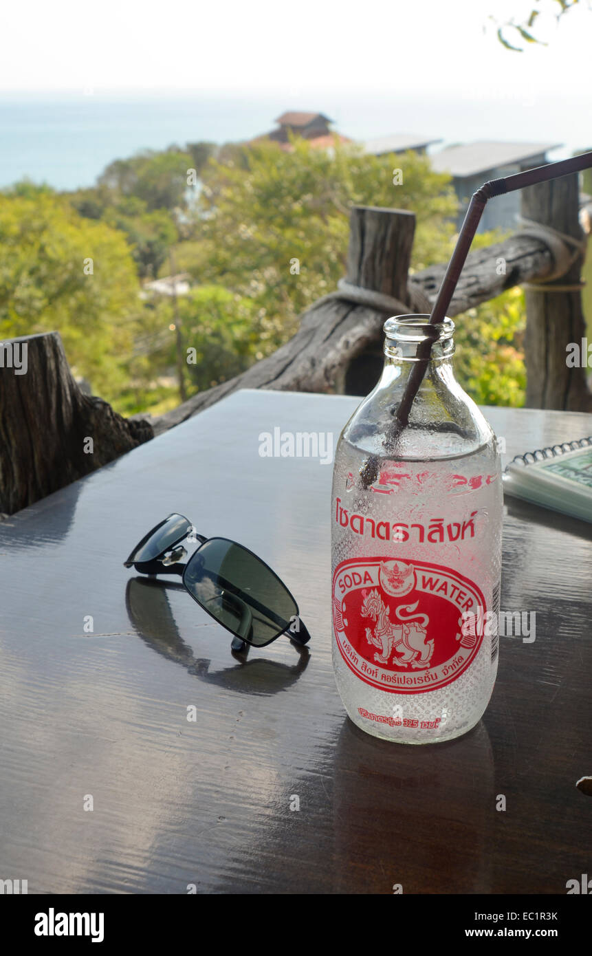 Thai soda water and sunglasses on the table of a hillside restaurant, Thailand Stock Photo