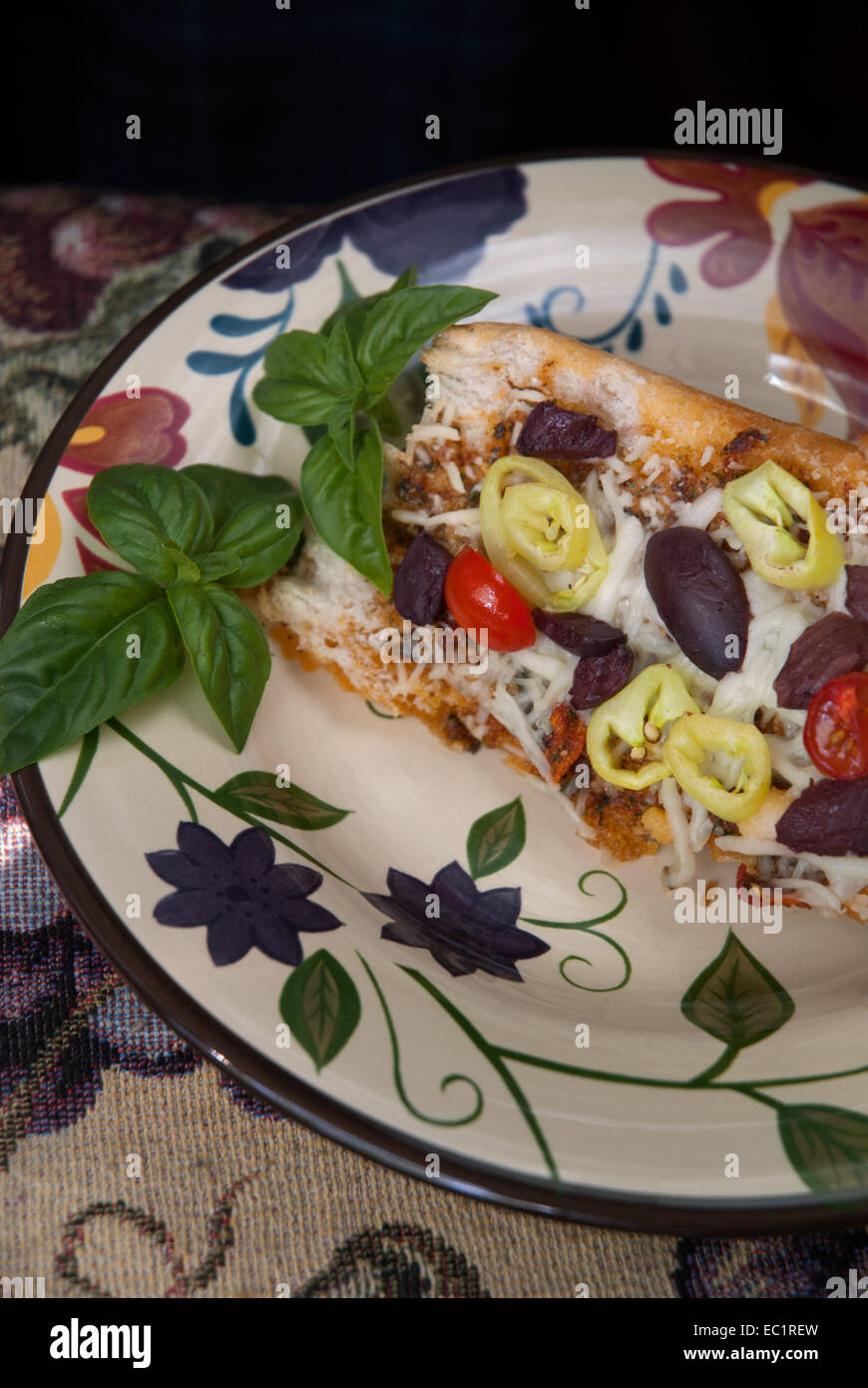 French bread topped with spiced olive oil, kalamata olives, sweet bananna peppers, cherry tomatoes and mozzarella cheese. Stock Photo