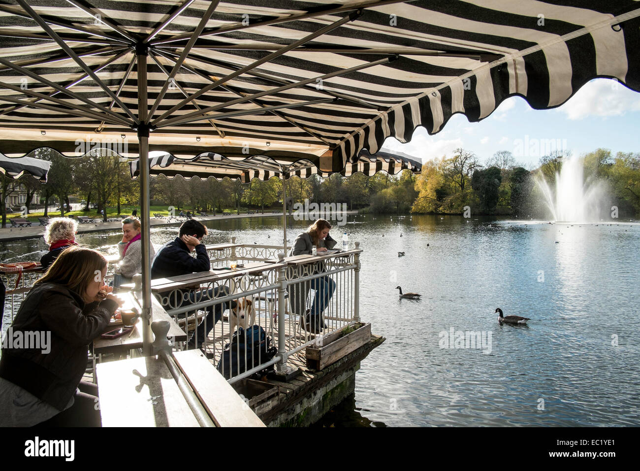 Terrace cafe overlooking the lake with a fountain, Victoria Park, Hackney, London, United Kingdom Stock Photo