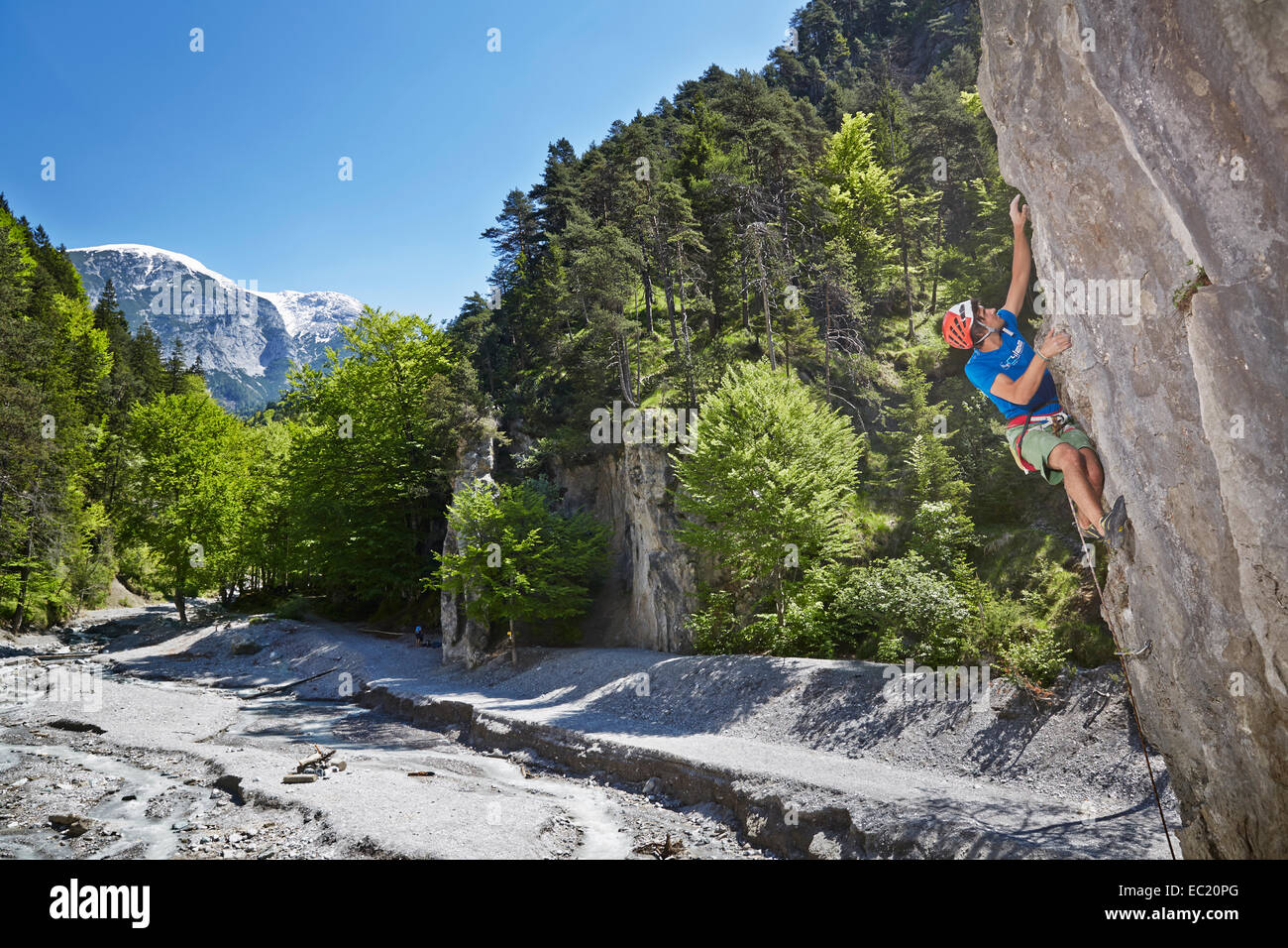 Sport climber wearing a helmet climbing a rock face, Ehnbachklamm