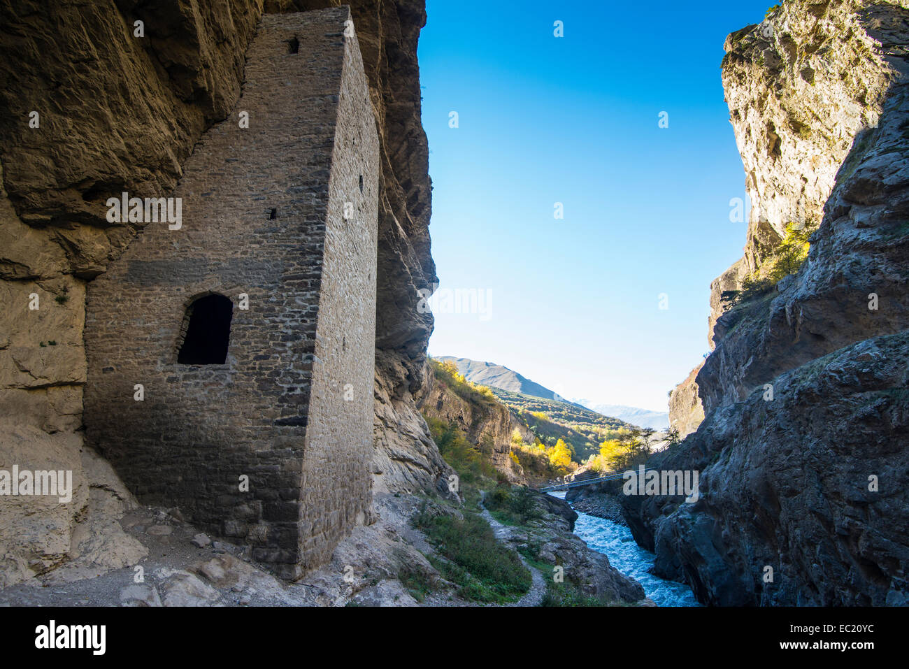 Chechen watchtowers under overhanging cliff on the Argun river, near Itum Kale, Chechnya, Caucasus, Russia Stock Photo