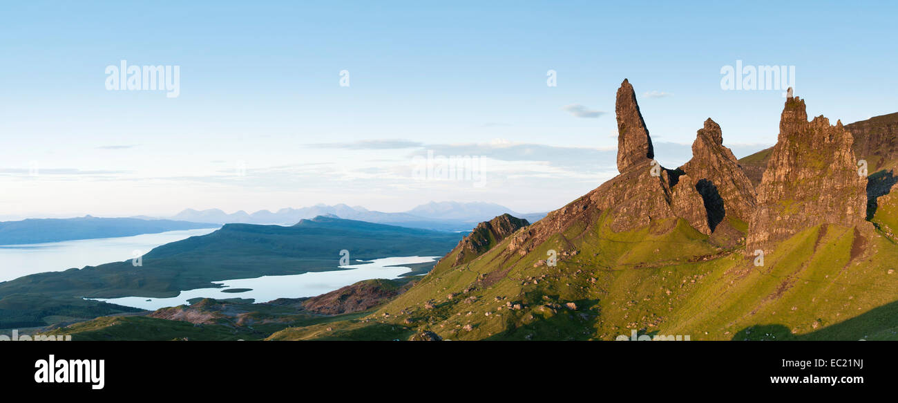 The Old Man of Storr at dawn with Loch Leathan behind, and the Cuillin Ridge in distance, Isle of Skye, Scotland, United Kingdom Stock Photo
