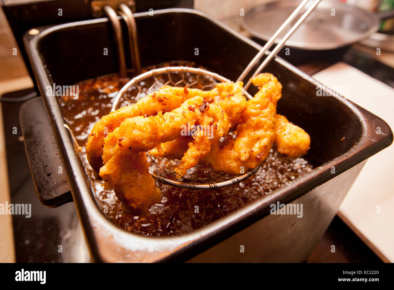 Chicken tenders fried in a deep fryer Stock Photo Alamy