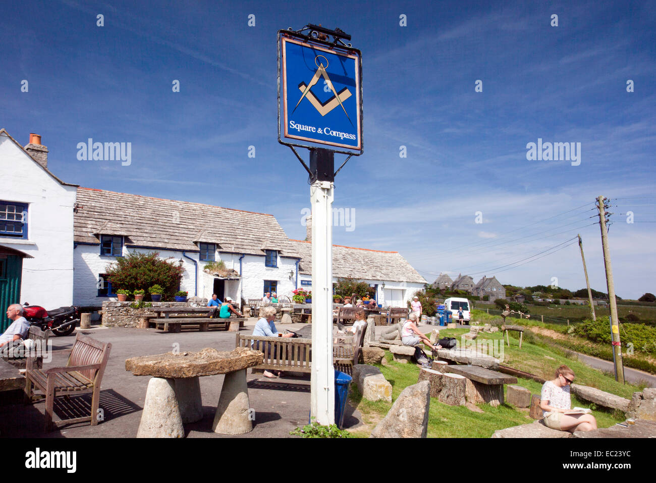 Purbeck stone tables and benches outside the Square and Compass pub in the Dorset village of Worth Matravers England UK Stock Photo