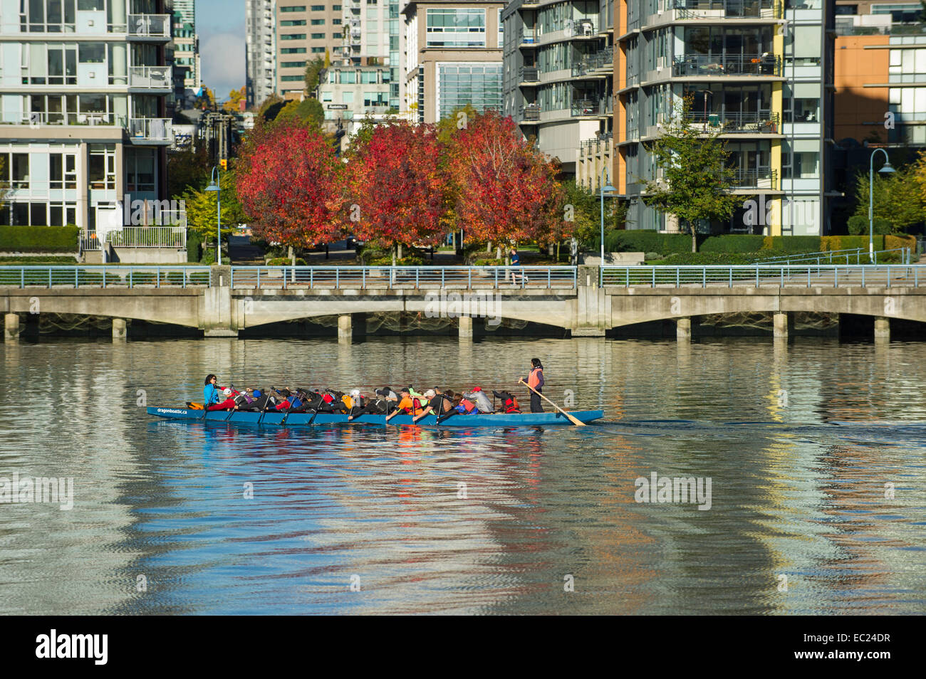 Dragon Boat traveling east along False Creek with a north view backdrop of downtown Vancouver Stock Photo