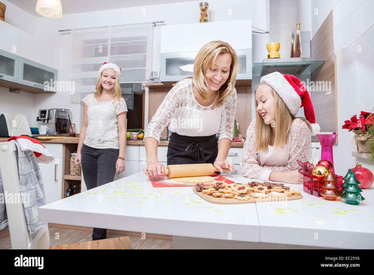 family making xmas cookies at home Stock Photo