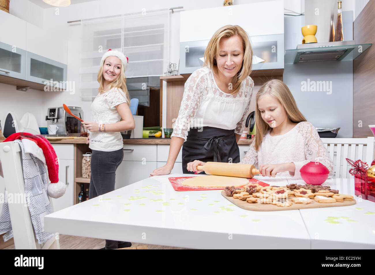 family making xmas cookies at home Stock Photo