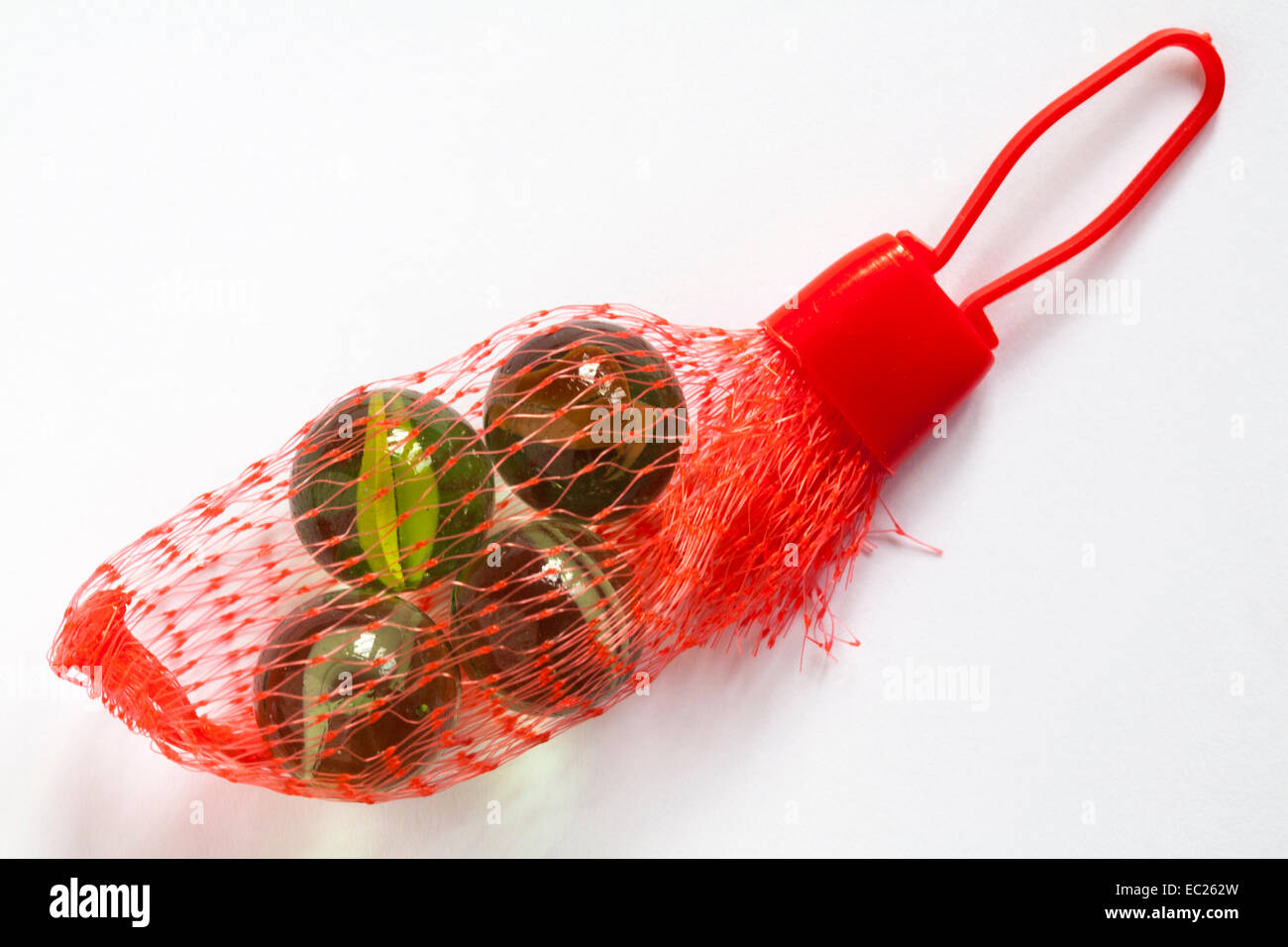 Small netting bag of marbles - present gift in Christmas cracker isolated on white background Stock Photo