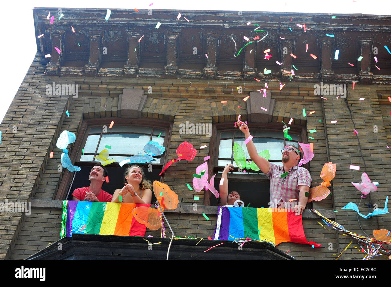 People look down from a open windows and throw confetti at the 2014 World Pride in Toronto. Stock Photo