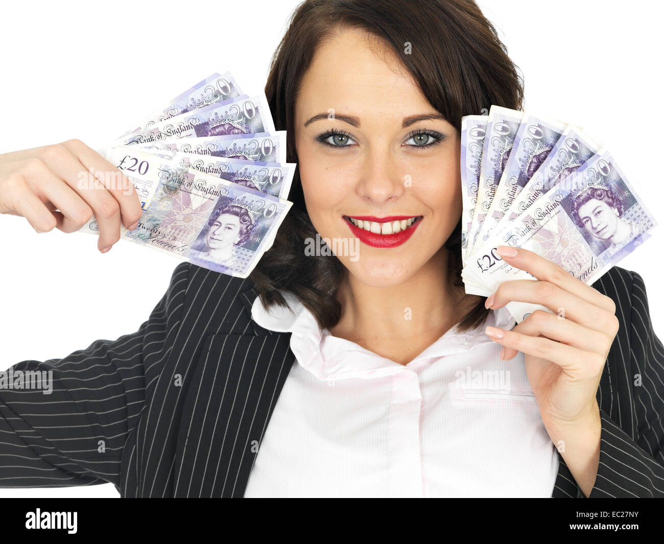 Successful Young Woman Excited Happy And Confident Celebrating Holding A Handful Of Money Isolated Against A White Background With A Clipping Path Stock Photo