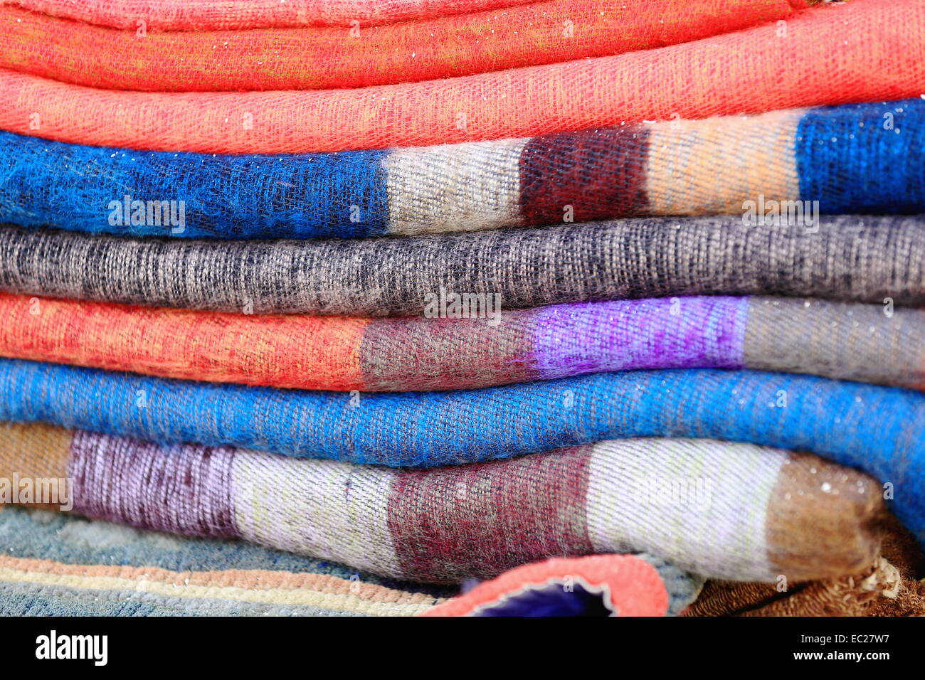 Set of colorful yak wool rugs for sale in a souvenir shop in Pokhara